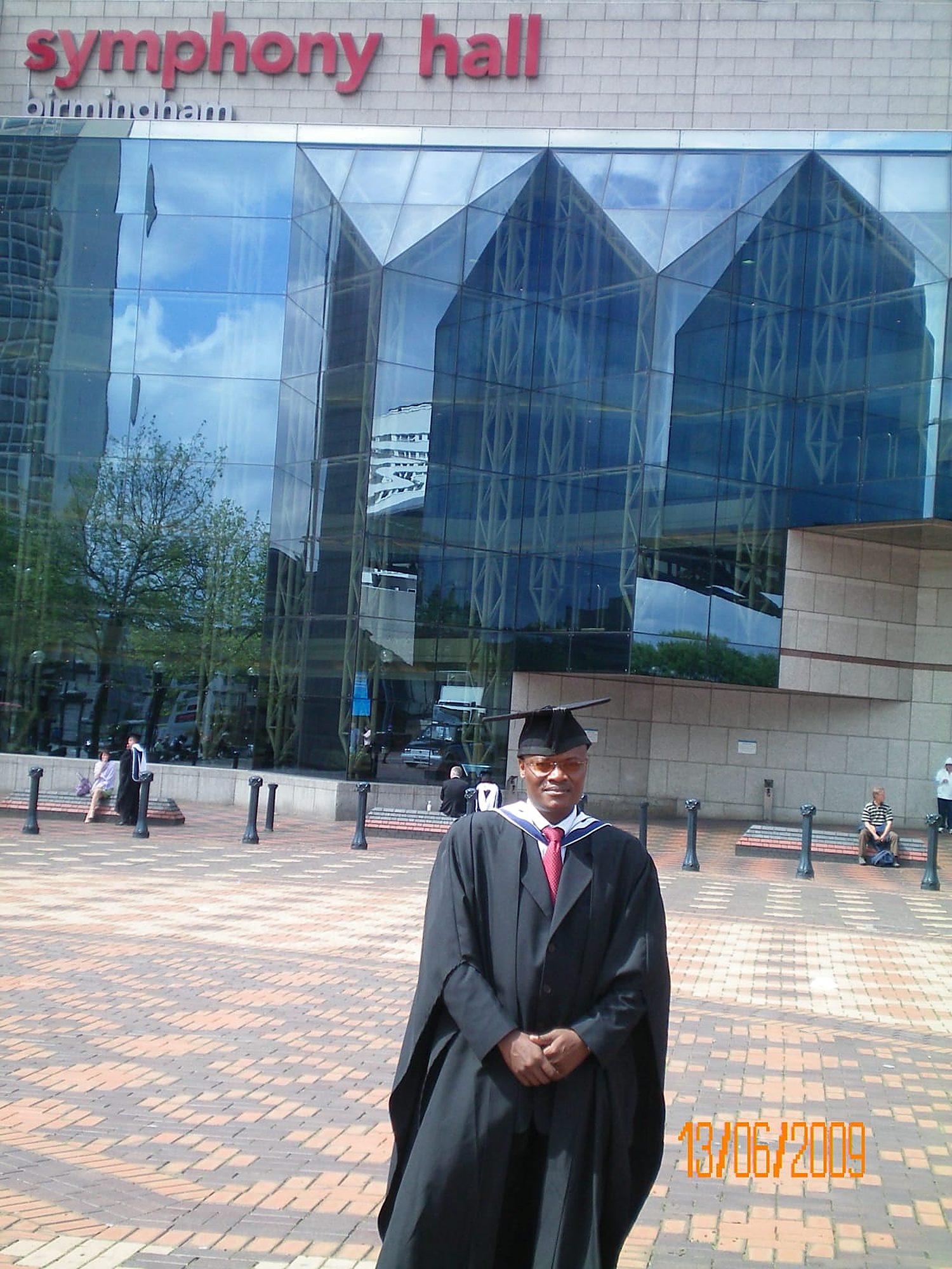 Francis Wanaswa in cap and gown outside Symphony Hall, Birmingham, on my graduation day in 2009