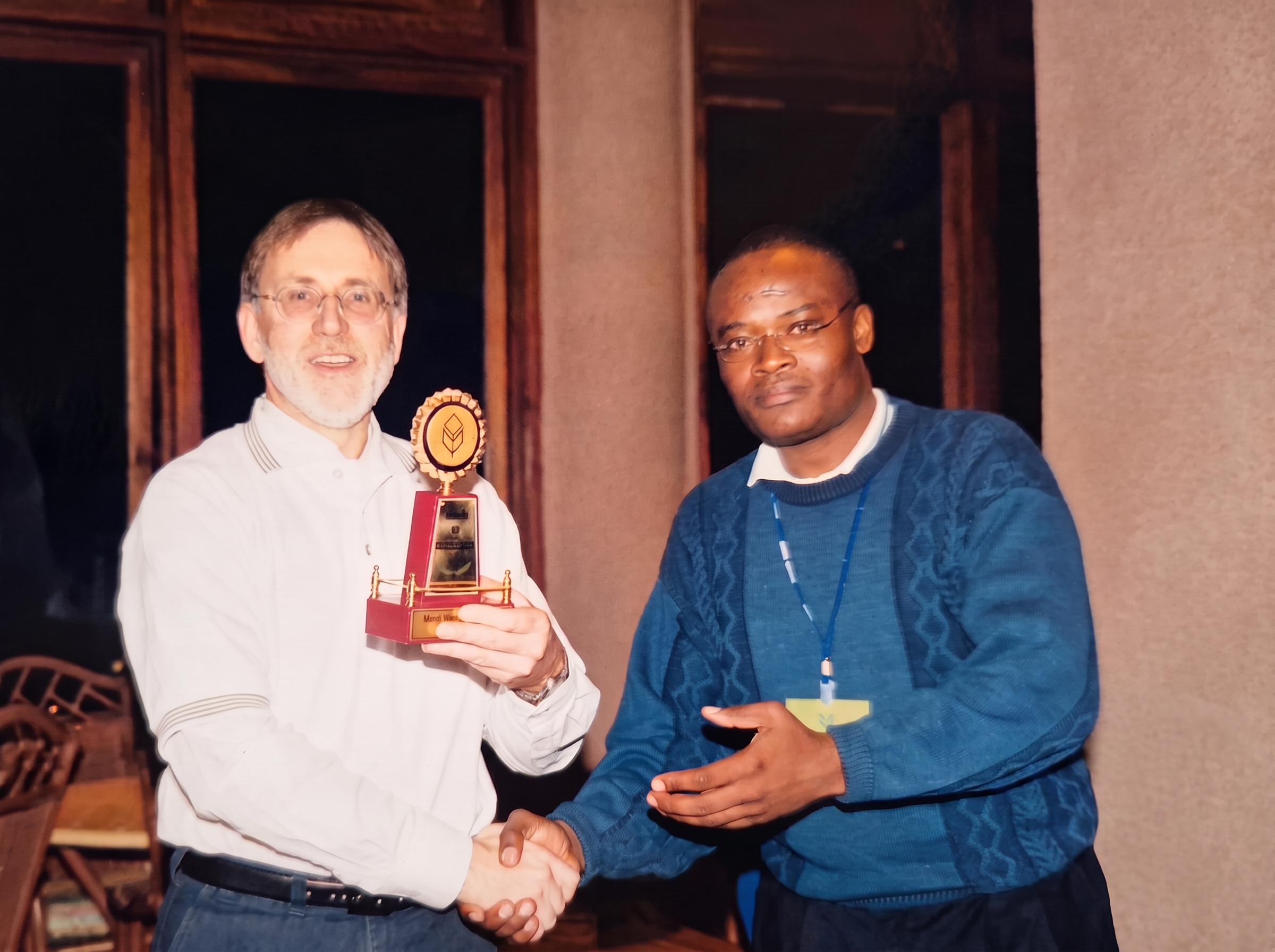 Francis Wanaswa receiving a recognition award from Mr Richard Fairburn, CEO and Managing Director of Unilever Tea East Africa